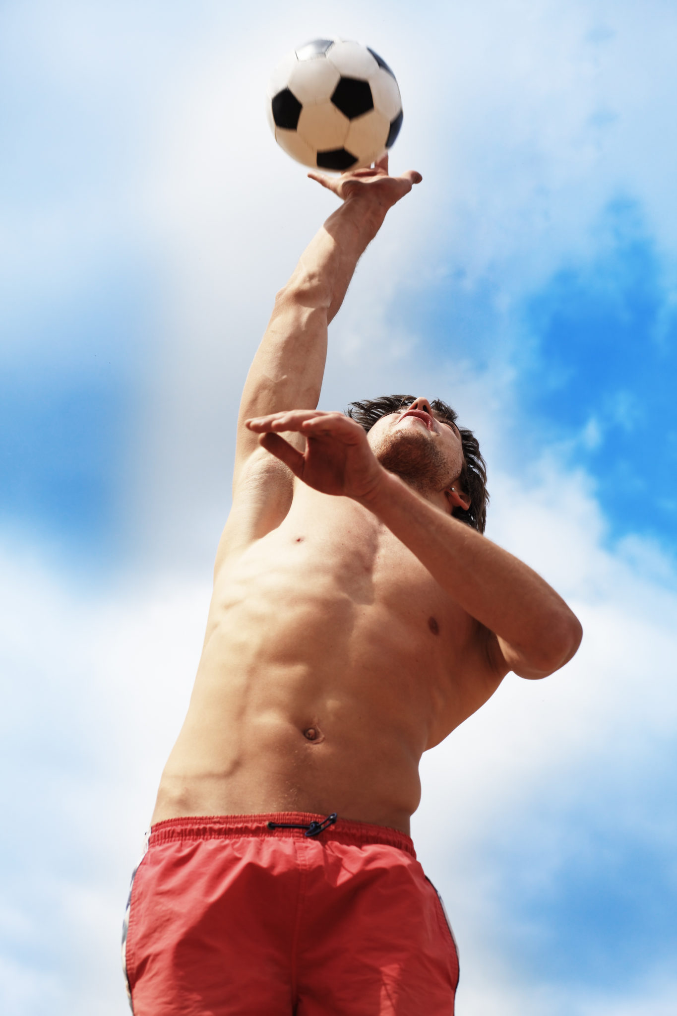 Bare chested man playing volleyball | Featured image for the Chest Physiotherapy page at Pivotal Motion.