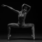 Black and white photo of a ballet dancer posing | featured image for Everybody Dance Now blog from Pivotal Motion Physiotherapy.