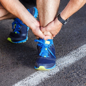 Photo of a person lacing up their shoes | Featured Image for Treating Ankle Sprains blog for Pivotal Motion Physiotherapy.