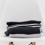Pile of winter clothes on chair | featured image for Seven Ways to Warm Up this Brisbane Winter.
