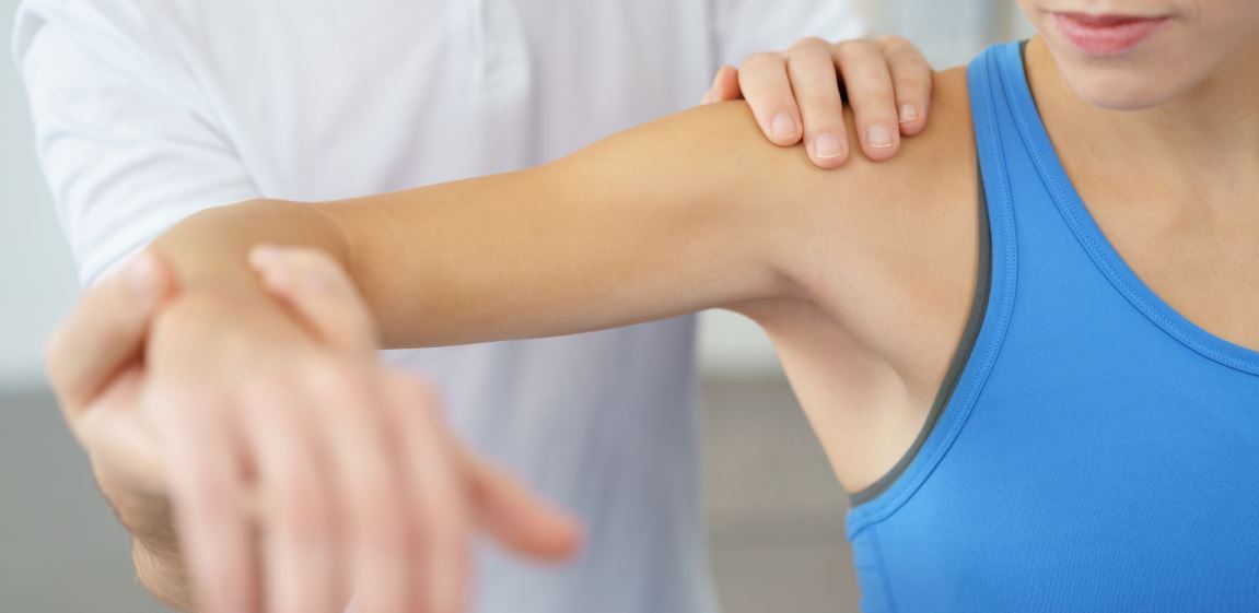 Realistic photo showing a doctor checking a patients rotator cuff | featured image for Home.