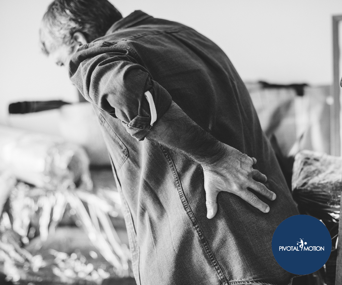 Man in pain holding his back | Featured image for 5 Tips for Getting Better Sleep with Night Pain blog for Pivotal Motion Physiotherapy.