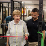 Woman and trainer practicing shoulder warm up exercises | Featured image for Shoulder Warm Up Exercises blog for Pivotal Motion Physiotherapy.