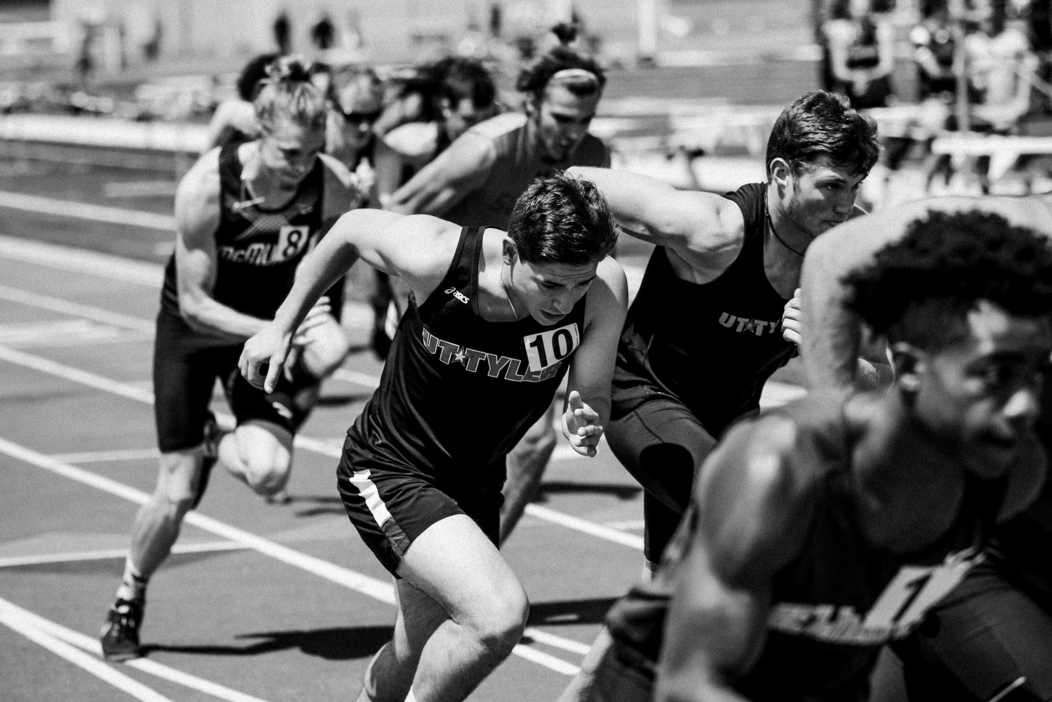 Group of men running on track