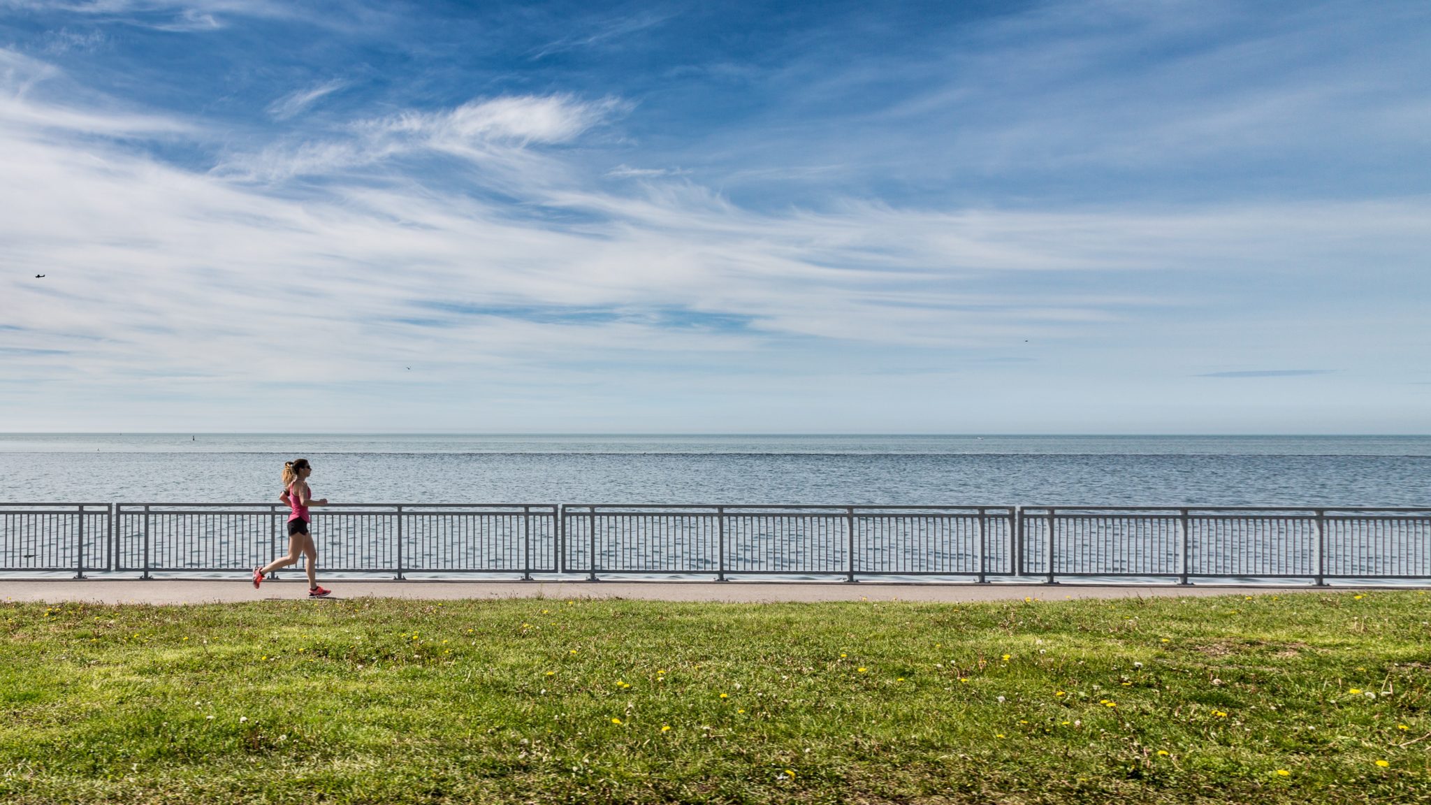 Woman running in front of a big ocean