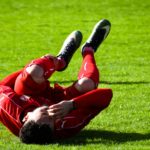 Soccer player experiencing leg cramps