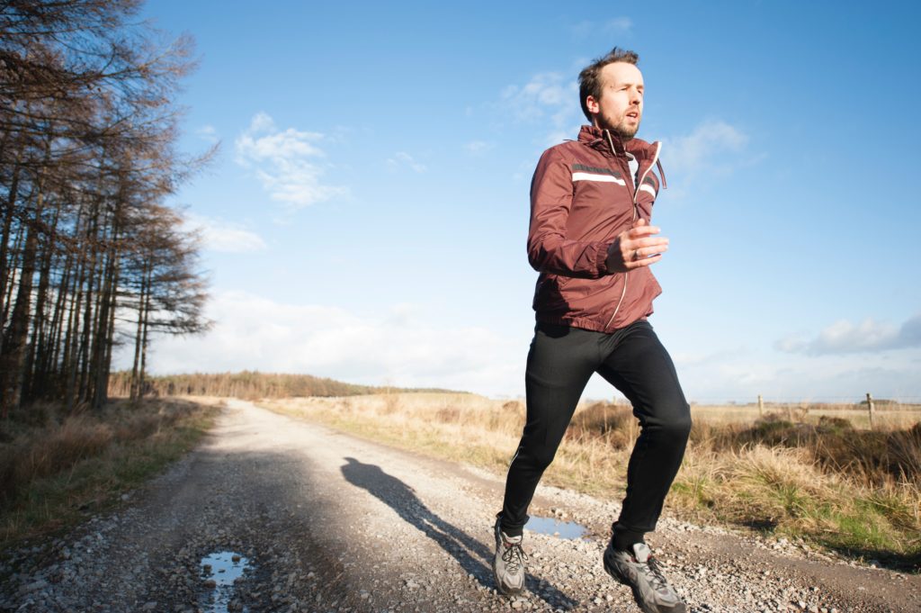 Man exercising in winter on gravel track | Featured image for What Made You Proud in 2020? blog for Pivotal Motion Physiotherapy.