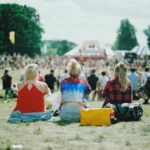 Group of girls sitting at festival.