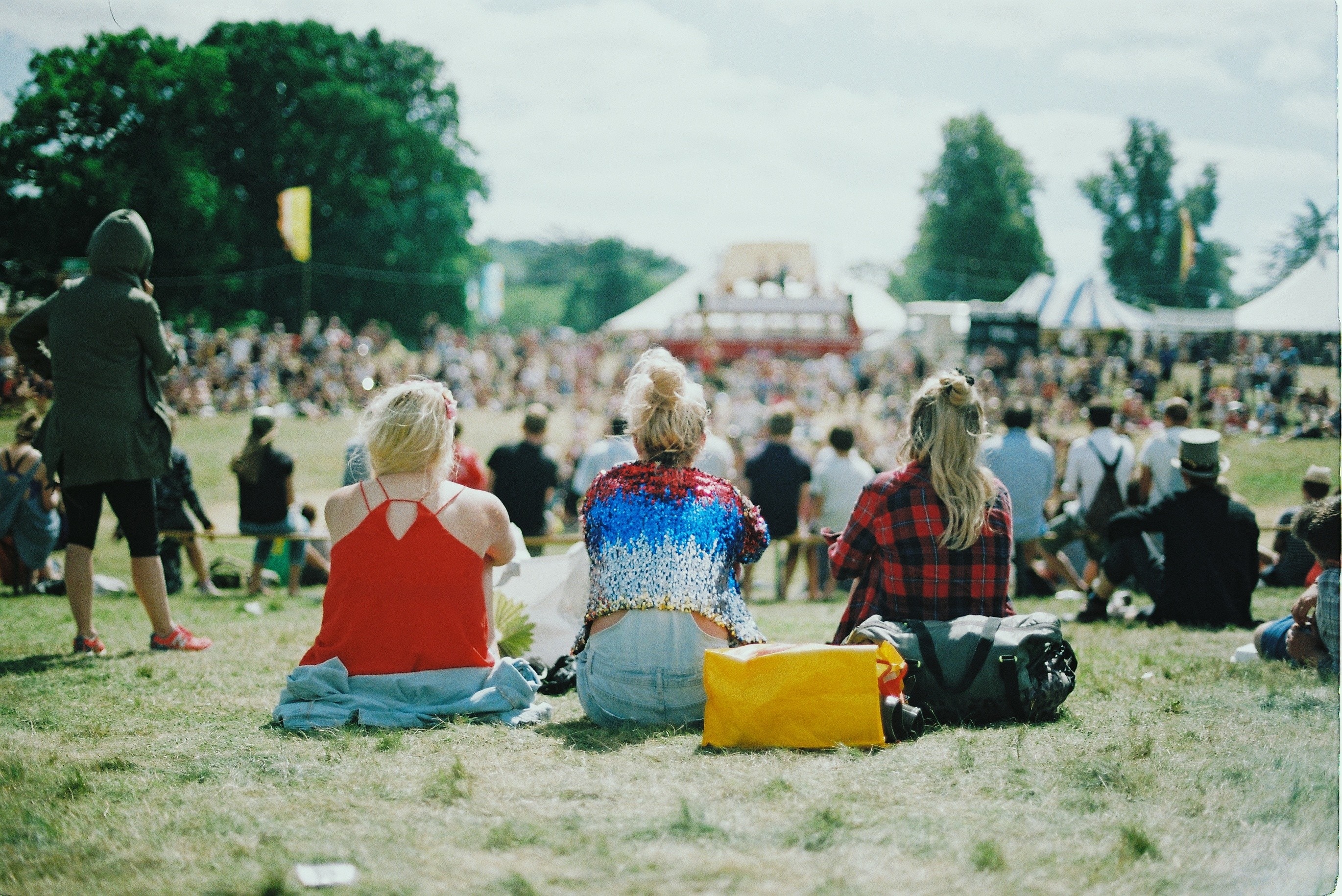 Group of girls sitting at festival.