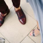 Image of person wearing burgundy shoes and woman wearing patterned heels.