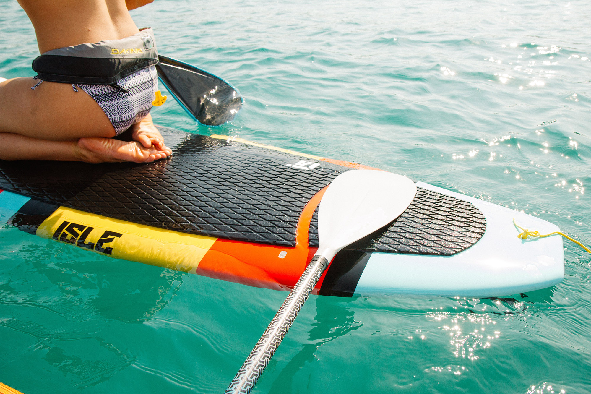 Person kneeling on surfboard