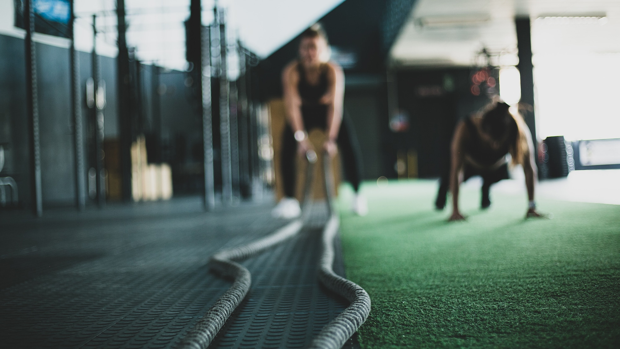 Slightly blurry image of a man doing a rope exercise