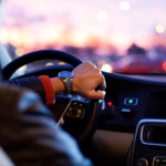 Up close image of a man wearing watch driving car