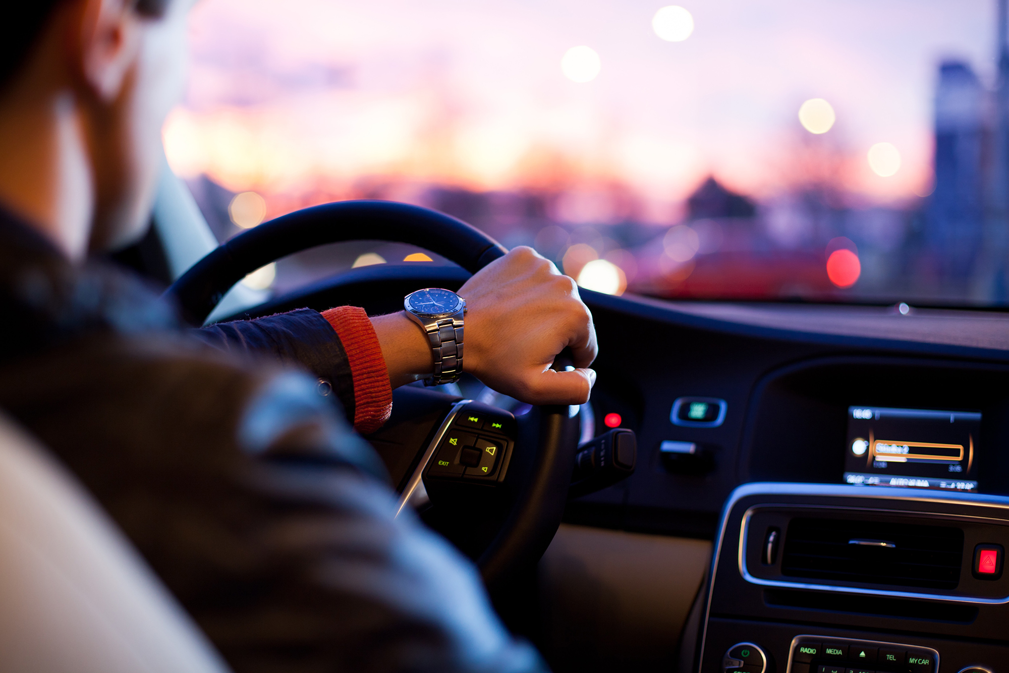 Up close image of a man wearing watch driving car