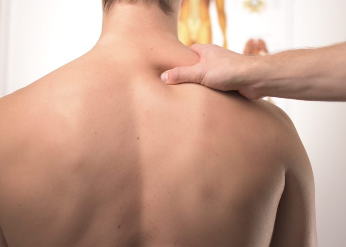 Image of person having shoulder massaged