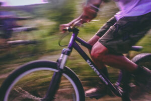 Image of guy riding bike in grassland