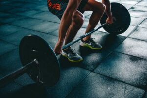 Photo of person leaning down and holding weights