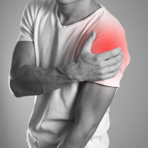 Guy holding his shoulder - Labrum tear | Featured Image for the Referred Shoulder Pain Treatment Page of Pivotal Motion Physiotherapy.