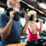 Older man lifting dumbells while seated | featured image for The Benefits of Exercise as We Age.