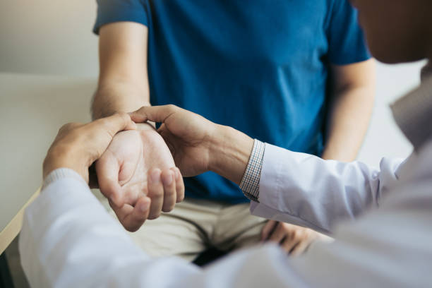 Doctor pressing their thumbs into a patient's wrist to check wrist bone | featured image for Common Wrist injuries.