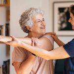 Trainer helping patient with should exercises | featured image for Why is physiotherapy important for seniors?