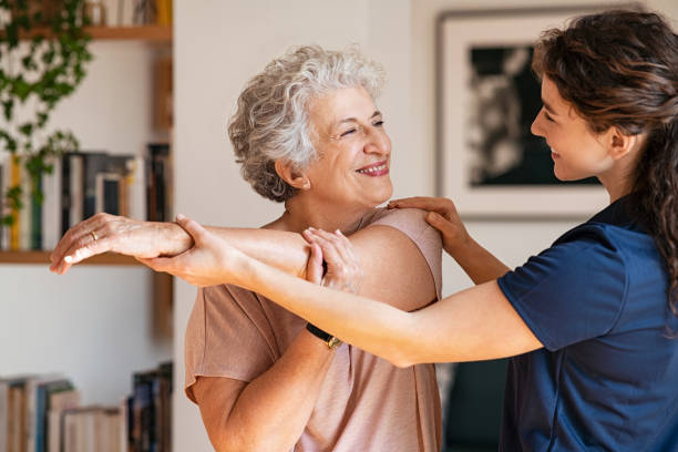 Trainer helping patient with should exercises | featured image for Why is physiotherapy important for seniors?