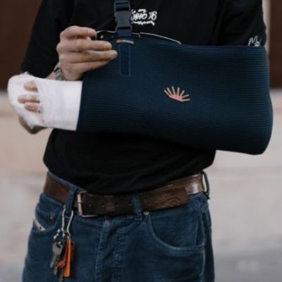 Person with their arm in a cast and sling | featured image for Arm Physiotherapy.