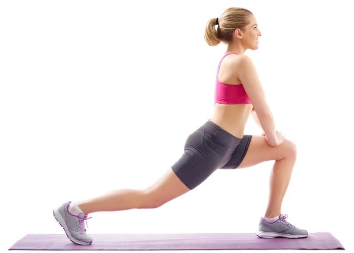 A woman in a lunge on a yoga mat | Featured image for Hip Physiotherapy.