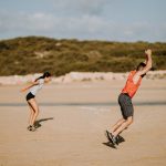 Two people jumping outside | Featured Image for Knee Physiotherapy