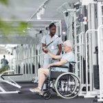 Photo of a doctor helping a patient do mobility exercises | Featured Image for Stone Man Syndrome blog for Pivotal Motion Physiotherapy.