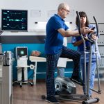 Doctor helping a patient with their exercise | Featured Image for Pivotal Motion Physiotherapy Exercise Programs blog for Pivotal Motion Physiotherapy.