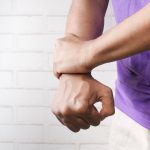 Man holding his wrist | Featured Image for Exercises for Wrist Pain