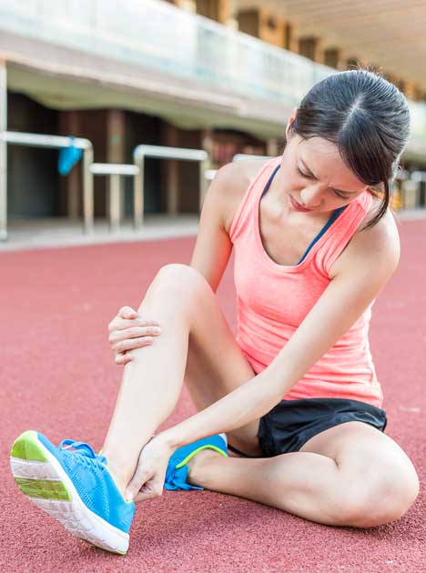 Runner holding her ankle | Featured Image for Feet & Ankle Physiotherapy