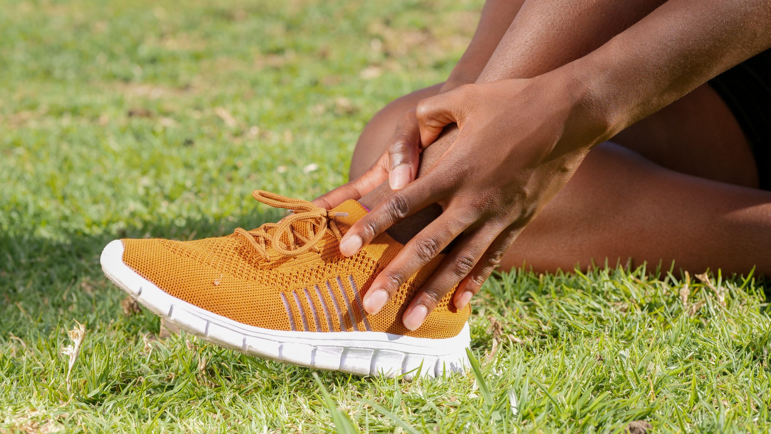 Person putting on a running shoe | Featured image for Surgery for Chronic Ankle Instability