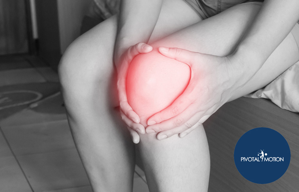Person holding an injured knee | Featured Image for the Common Causes of Injury Blog by Pivotal Motion Physiotherapy