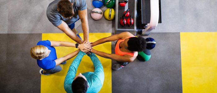 Group of four people celebrating their successful training | Featured image for the Type 2 Diabetes Management page at Pivotal Motion Physiotherapy.