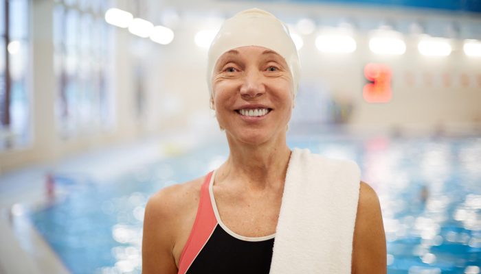 Smiling woman at a pool | Featured image for Hydrotherapy Physio page at Pivotal Motion Physiotherapy.