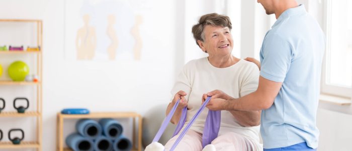 Elderly woman practicing mobility exercises | Featured Image for the Stretch Classes Page by Pivotal Motion Physiotherapy.