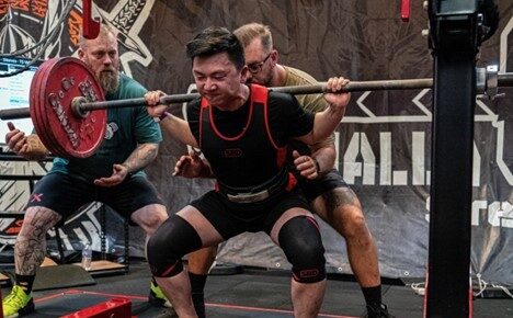 Man competing in powerlifting competition